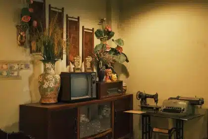Retro 1980s living room with VHS tapes, boombox and neon movie posters