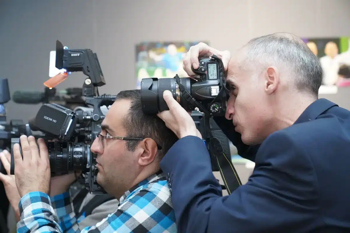 International press and photographers covering a major festival event with media presence.