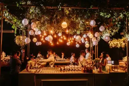Elegantly dressed guests at a formal black-tie gala event in a grand Venetian venue with candlelit tables and contempora