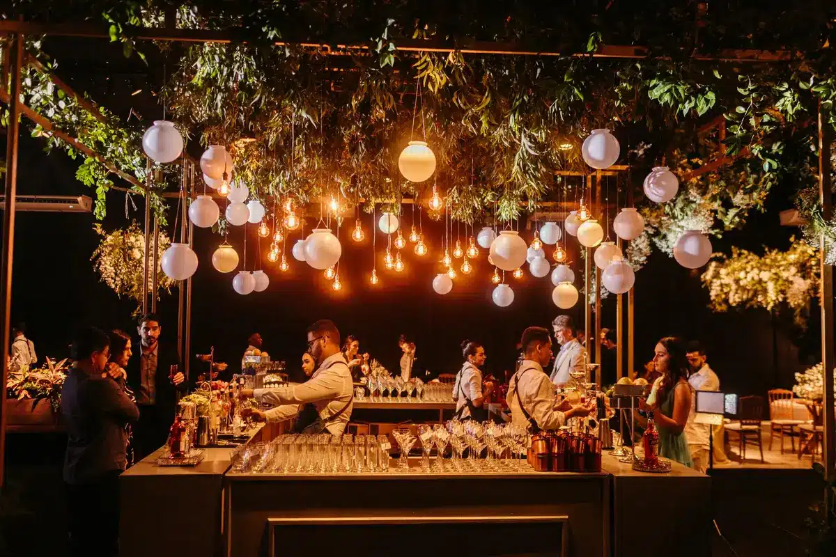 Elegantly dressed guests at a formal black-tie gala event in a grand Venetian venue with candlelit tables and contempora