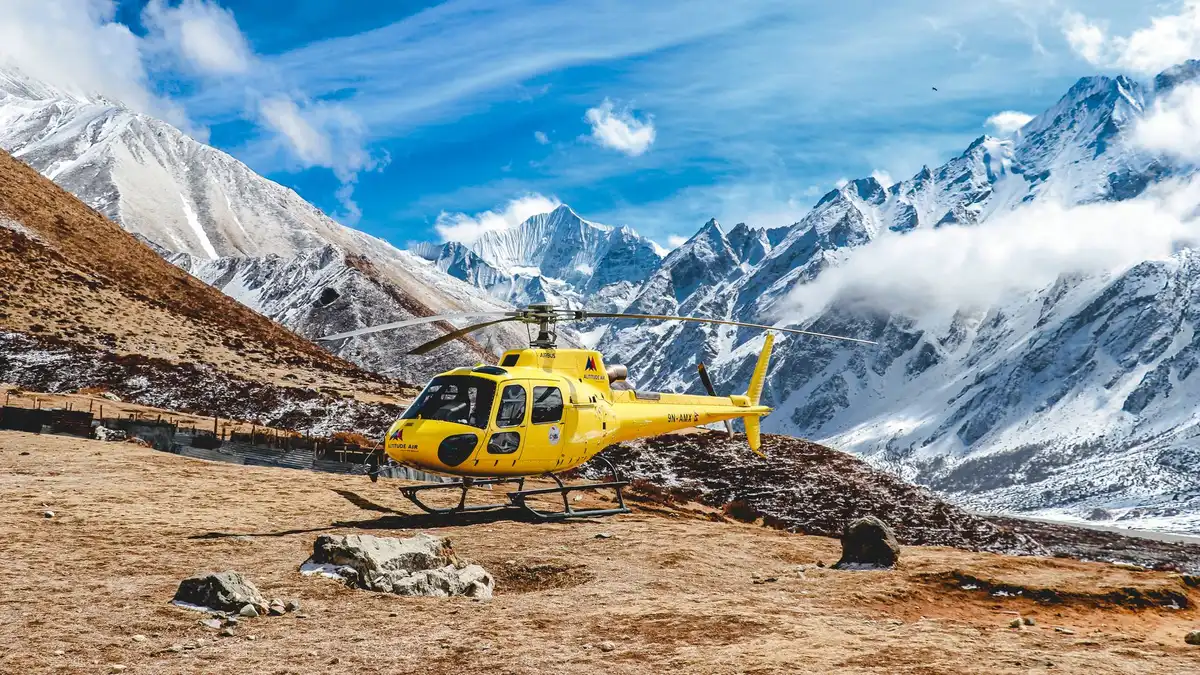 Aerial view of mountain terrain below, representing the high-altitude challenges cast members face.