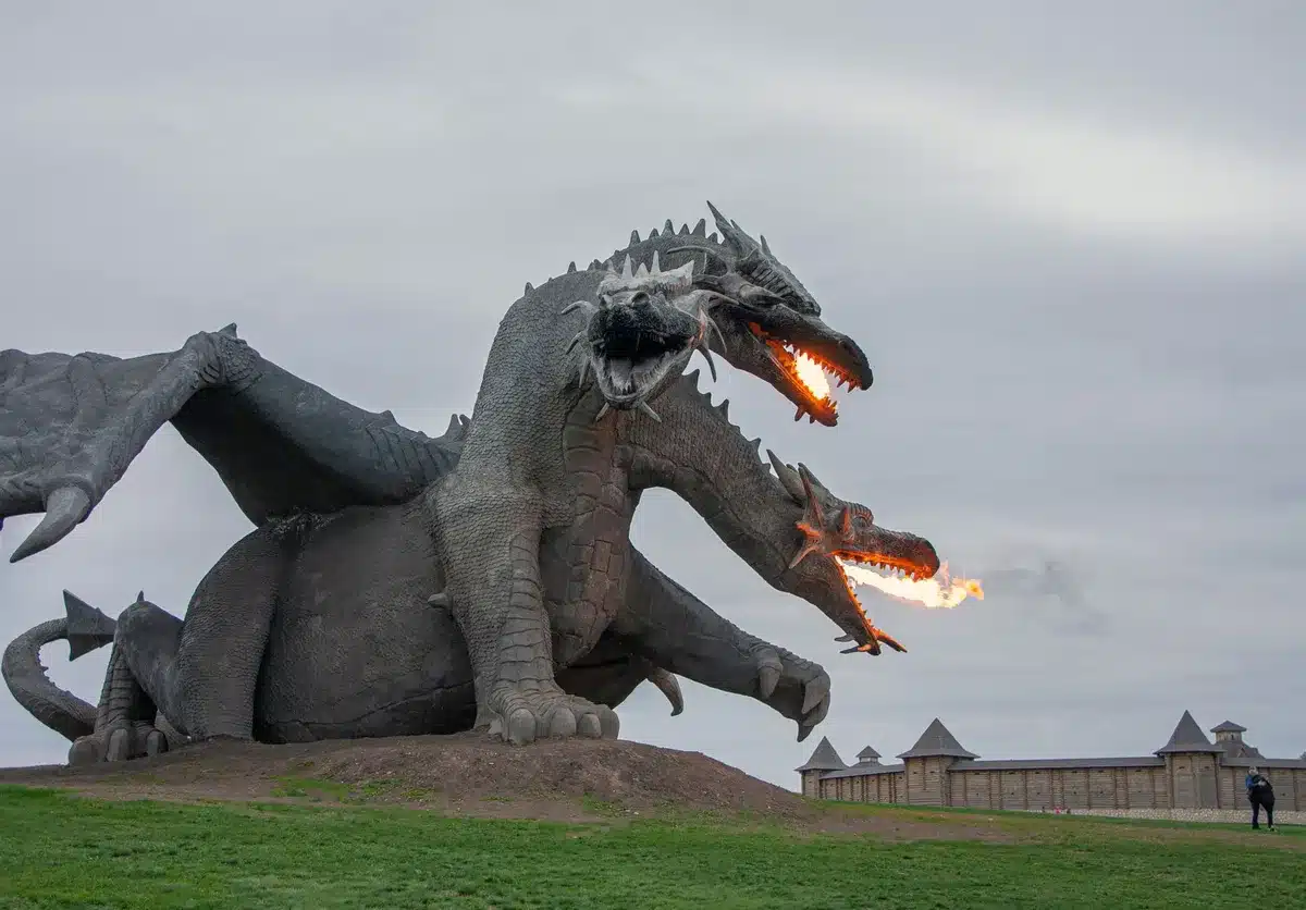 Dragonfire engulfs a medieval battlefield as soldiers scatter in chaos