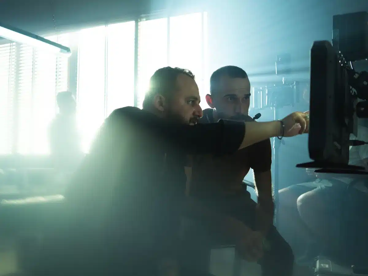 Film director watching crew on set during production
