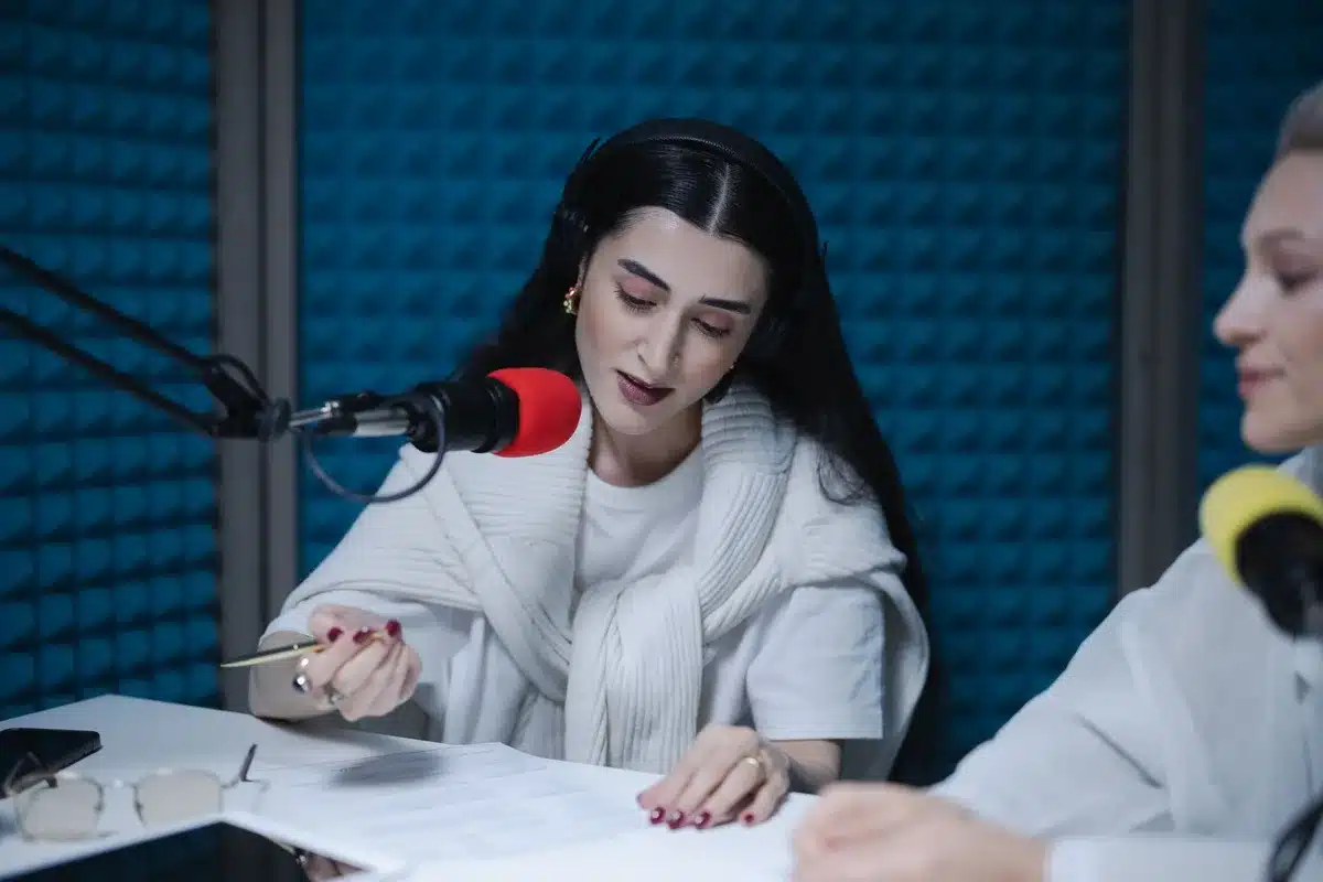 Broadcast professional at studio microphone during live recording