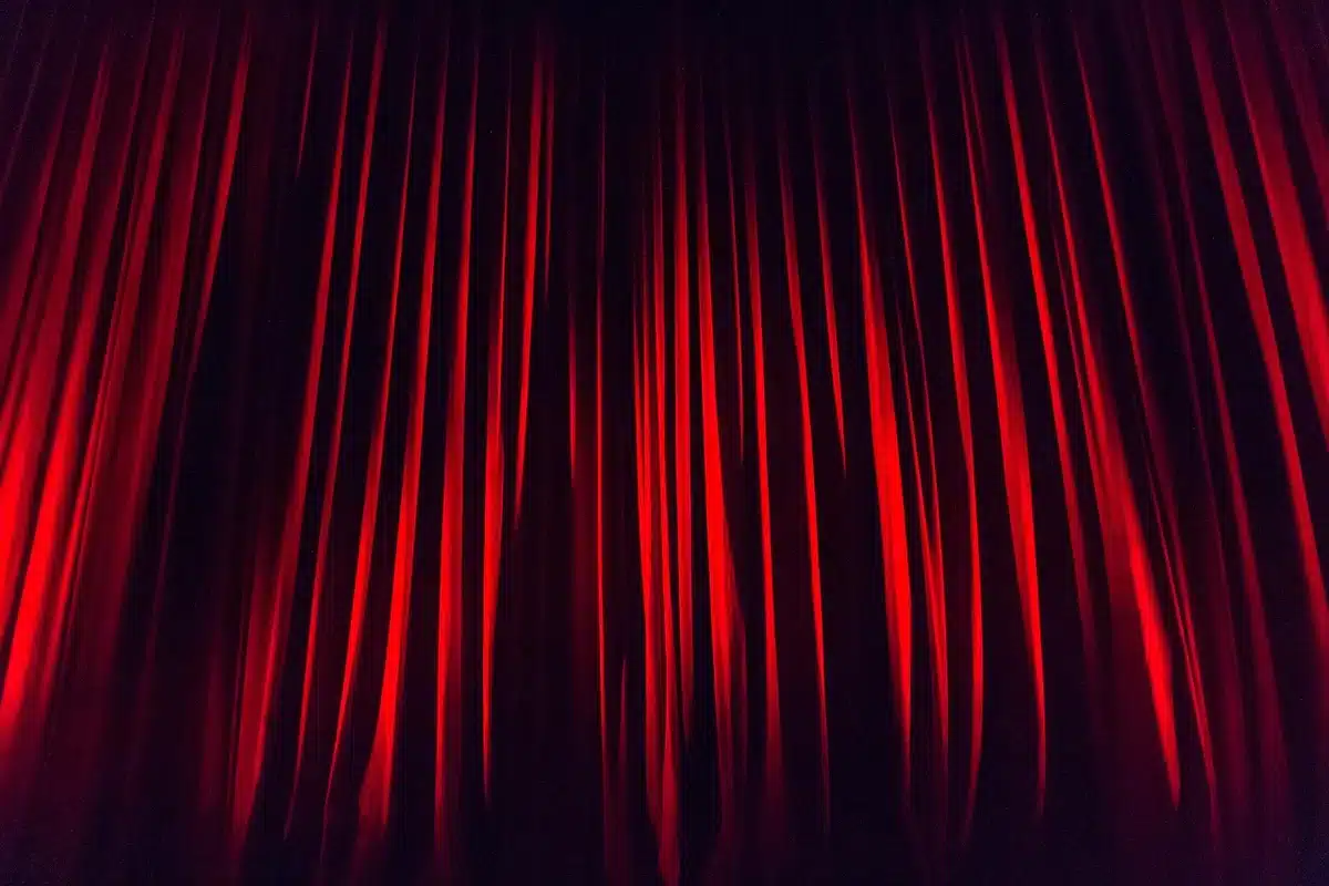 A vibrant Broadway stage set with detailed architectural elements and lighting design