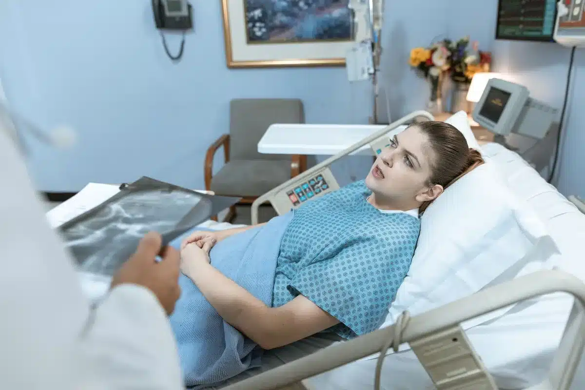 Hospital setting with medical staff monitoring patient condition during recovery