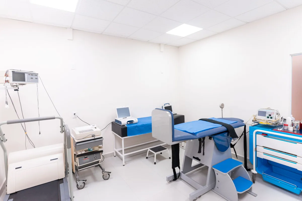 Hospital room with medical monitors and surgical equipment in soft lighting