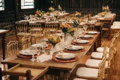 An elegantly set dining table with place cards and glassware, ready for guests but empty, in a modern home.