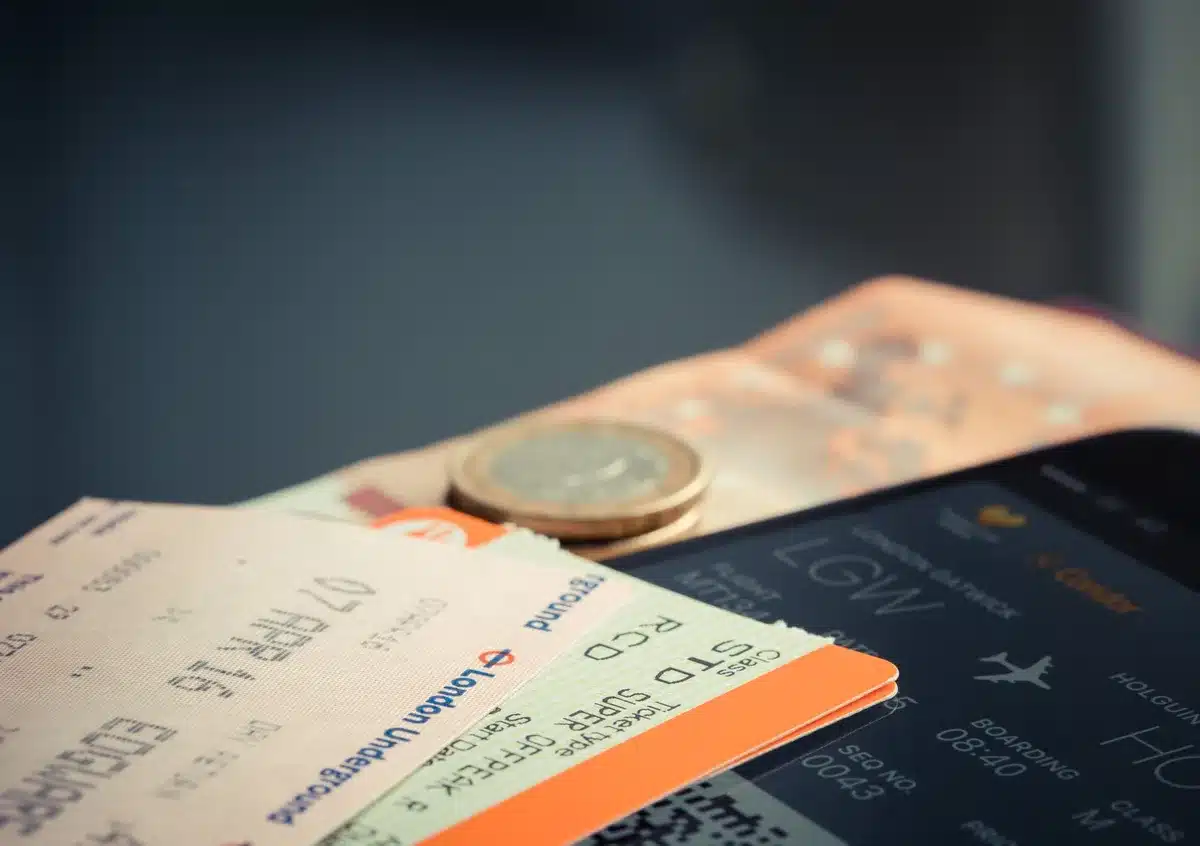 Person browsing ticket resale websites on a computer or mobile device, comparing prices and availability