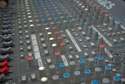 Professional recording studio with microphone and mixing console in warm lighting