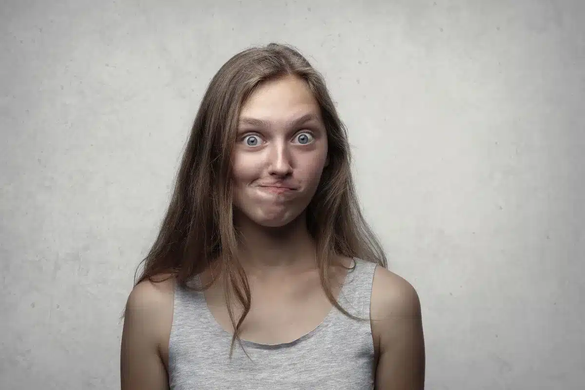 Deadpan facial expression juxtaposed with classical or ornate text, illustrating the meme's contrast between highbrow la