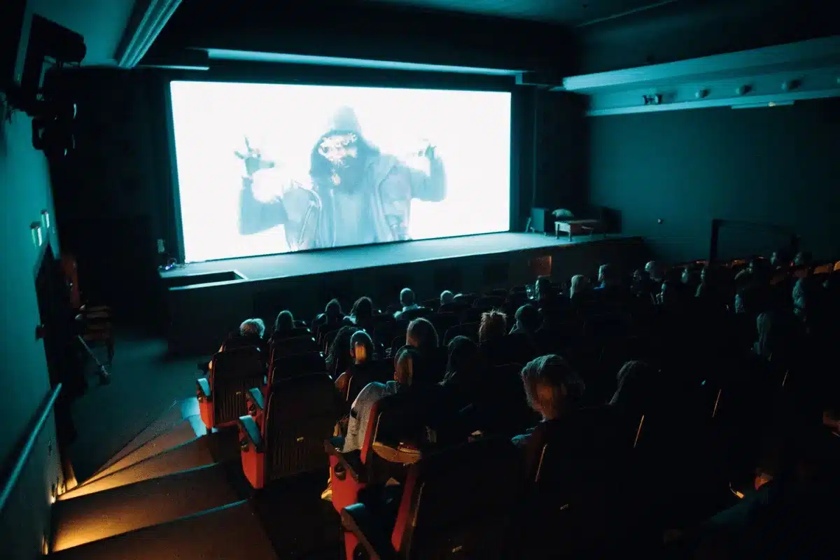 Theater audience members seated during a film premiere screening
