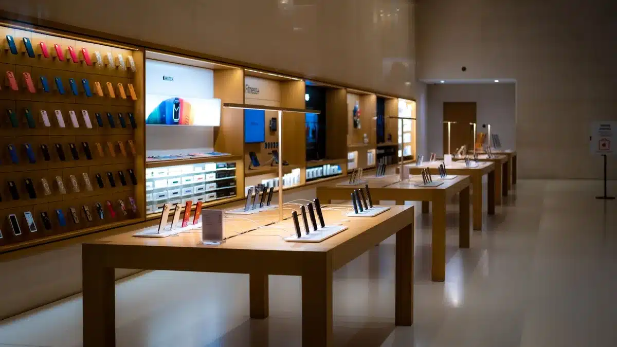 Person comparing mobile devices and tech gadgets in a store or online