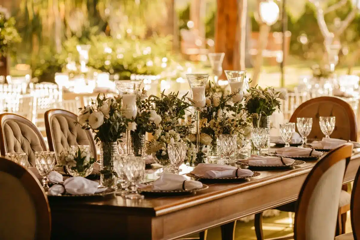 Upscale country house reception hall with period décor, candlelit tables and guests in formal wear