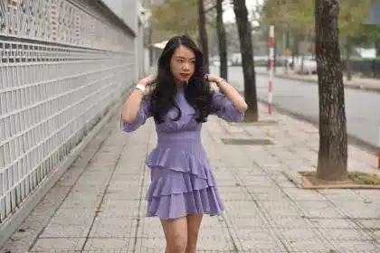 Barbie doll in a purple dress with drop earrings on display