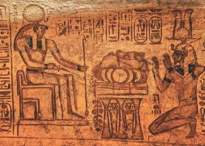 Open history book with timelines, ancient artifacts, and modern objects arranged on a desk