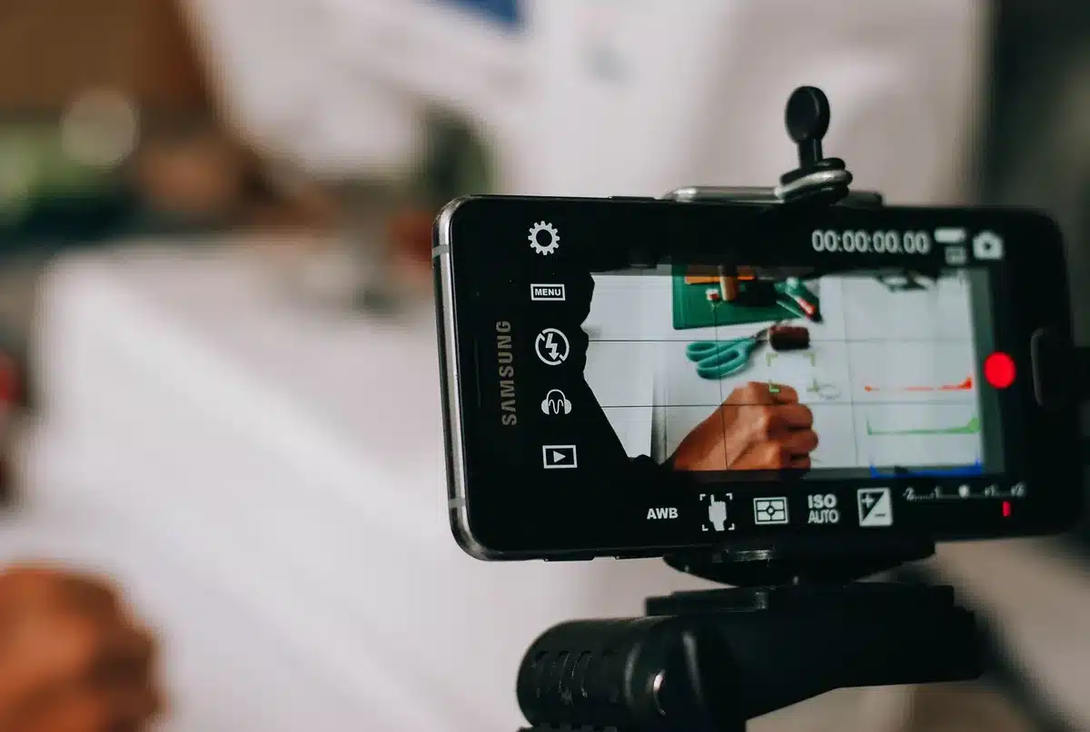 Person recording an audition video on a smartphone with good lighting and clear framing
