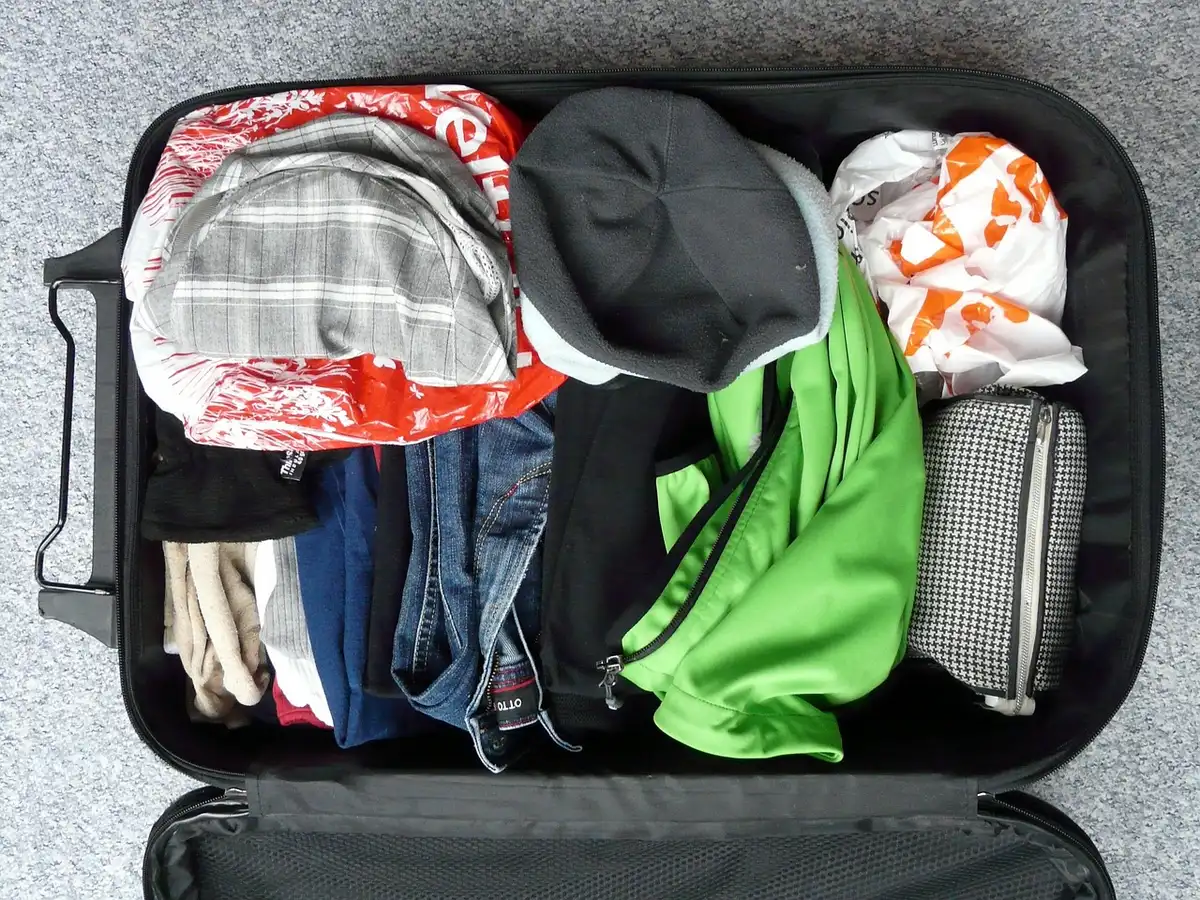Open suitcase with travel documents and a cancellation notice