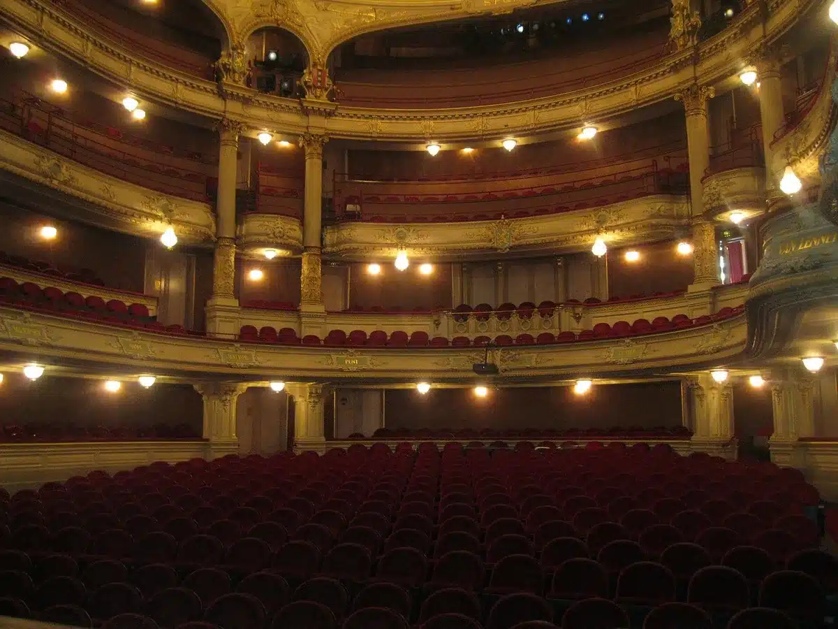 Darkened West End stage behind closed curtain