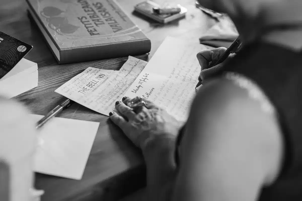 Closeup of journal pages with handwritten notes, sketches and script fragments