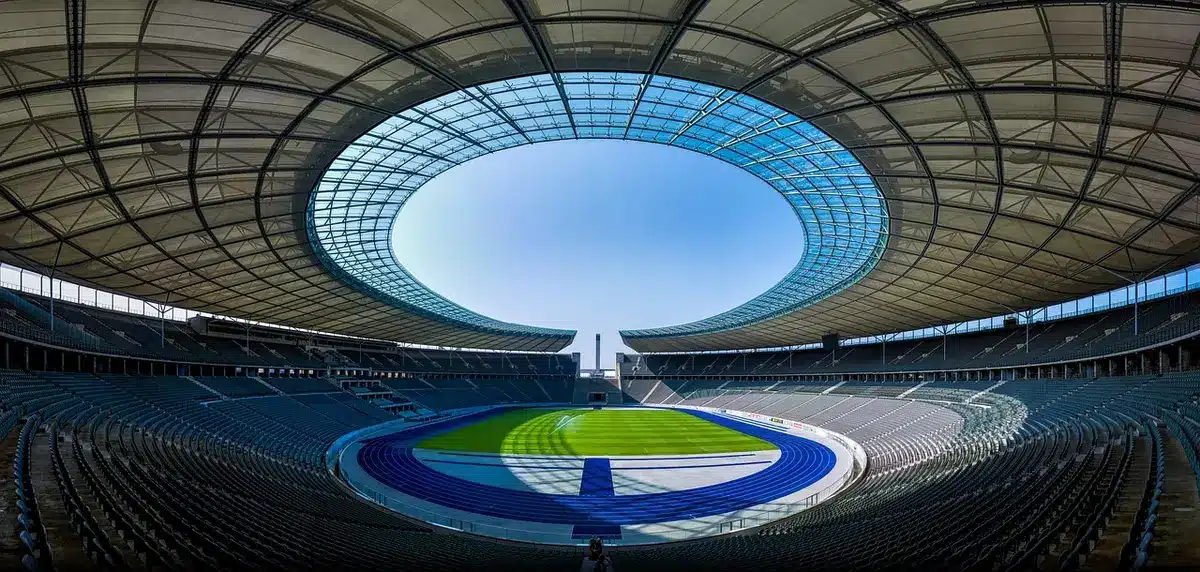 Empty stadium entrance with security barriers and ticketing booths