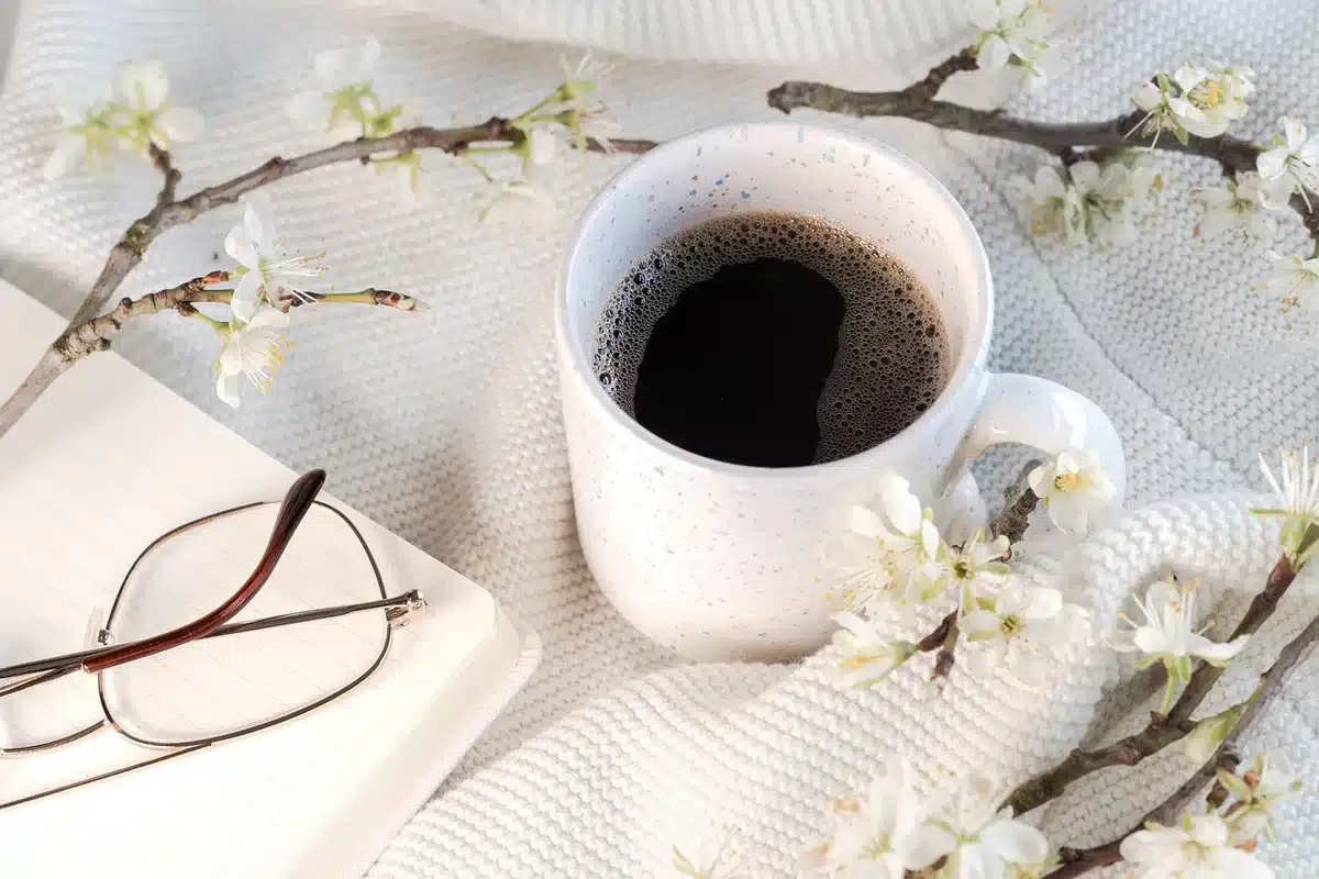 Person with notebook and coffee symbolizing responsibility and busy life