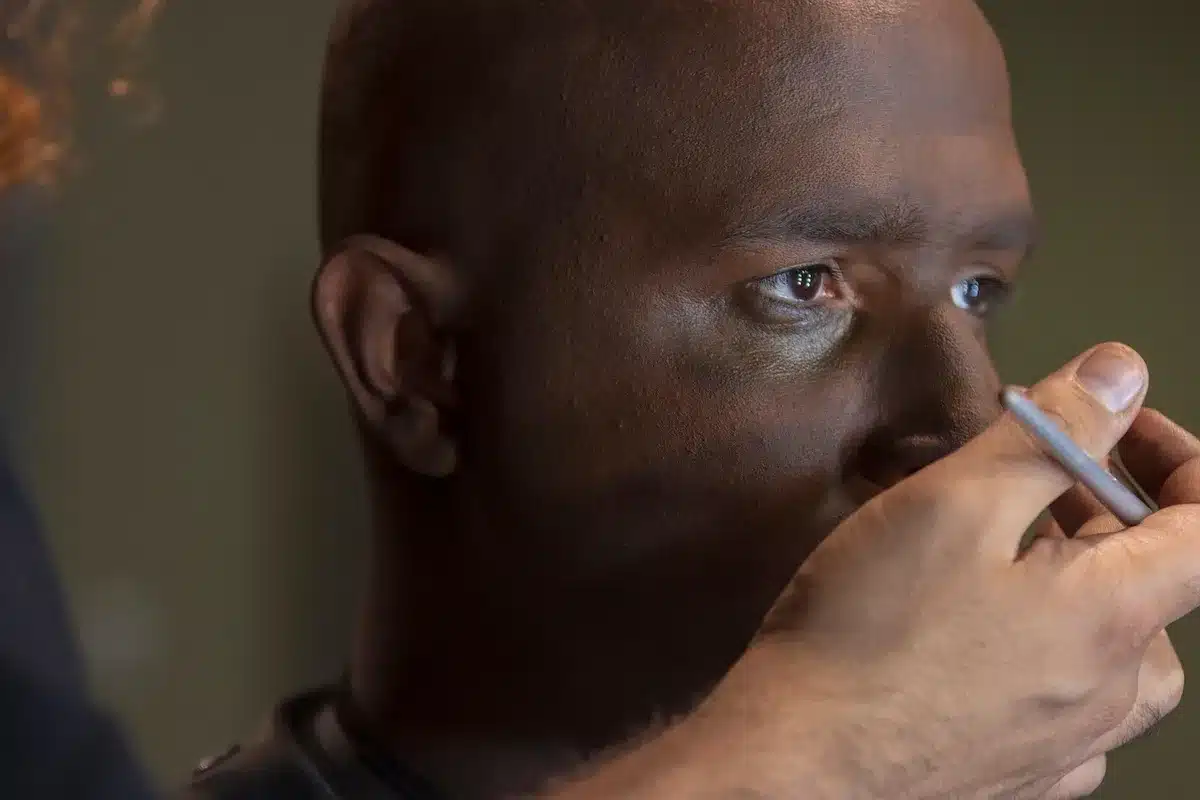 Actor working on a small film set, preparing a role