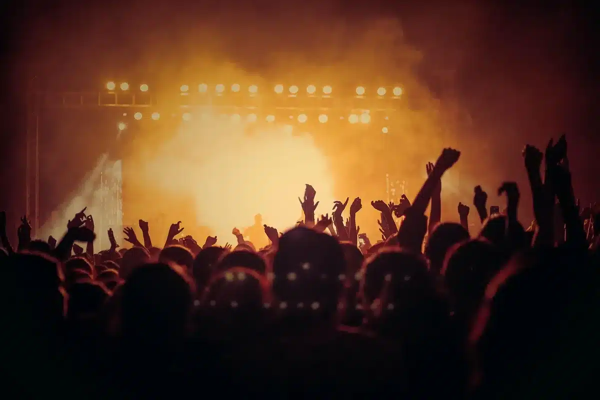 Rebel Stage area at an outdoor festival crowd near a park stage