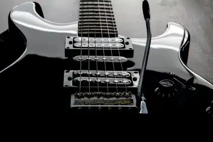 Backstage corner with music stand, guitar case and stage light suggesting a recent performance