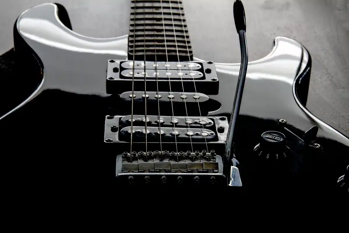 Backstage corner with music stand, guitar case and stage light suggesting a recent performance