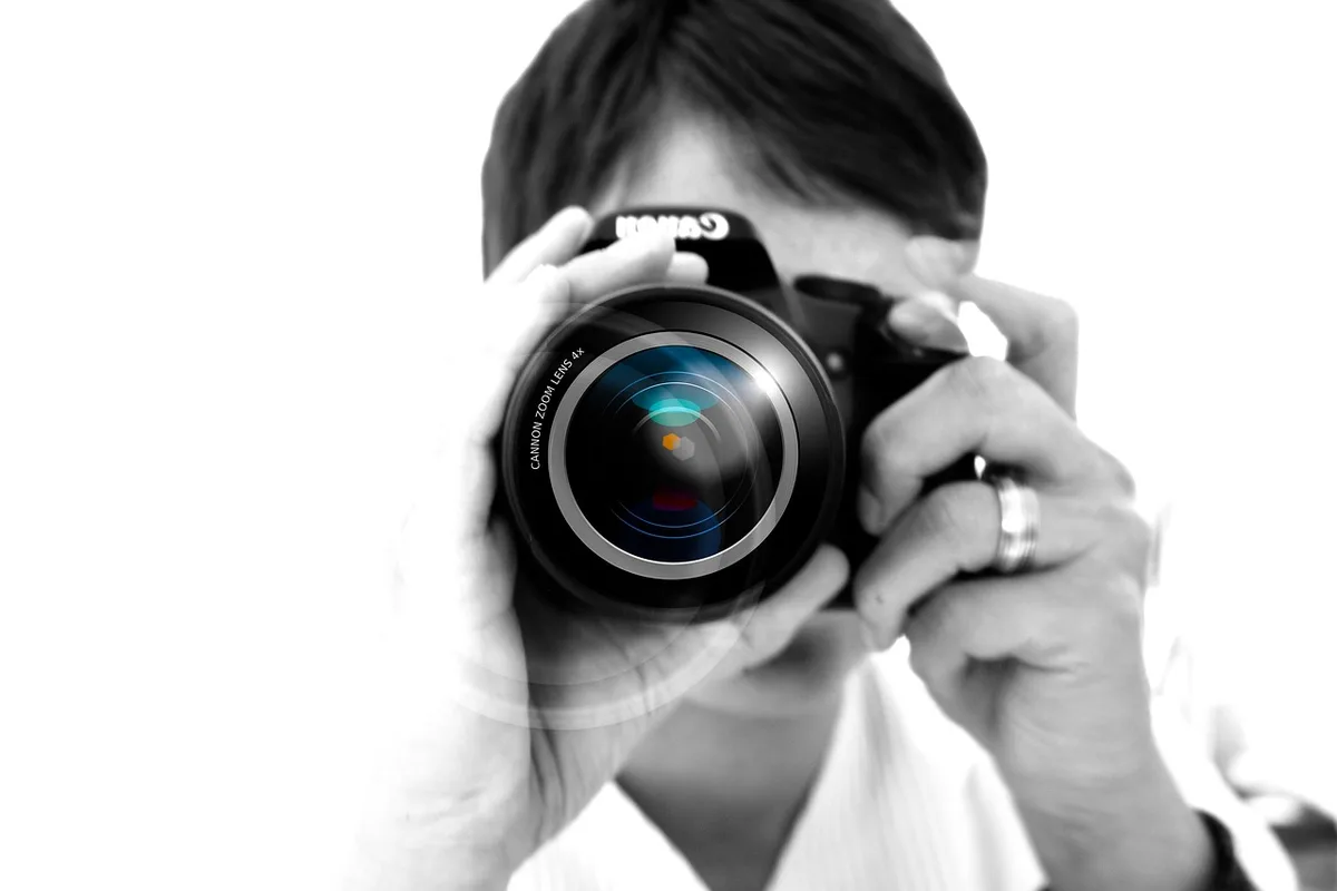 Anonymous photographers and flashing cameras at a red carpet