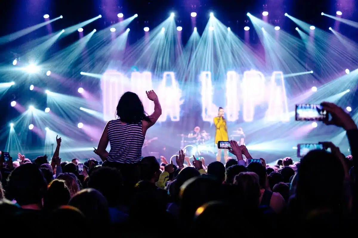 Public reacting at a 1990s-style hip-hop concert crowd