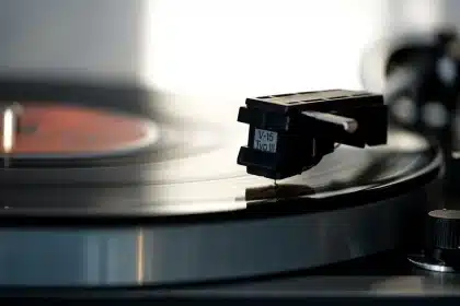 Vinyl record playing on turntable in recording studio setting