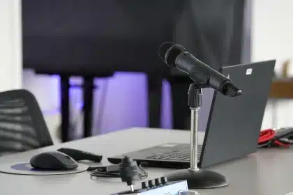 Anonymous studio desk with microphone, laptop and jacket suggesting a music-and-tech crossover