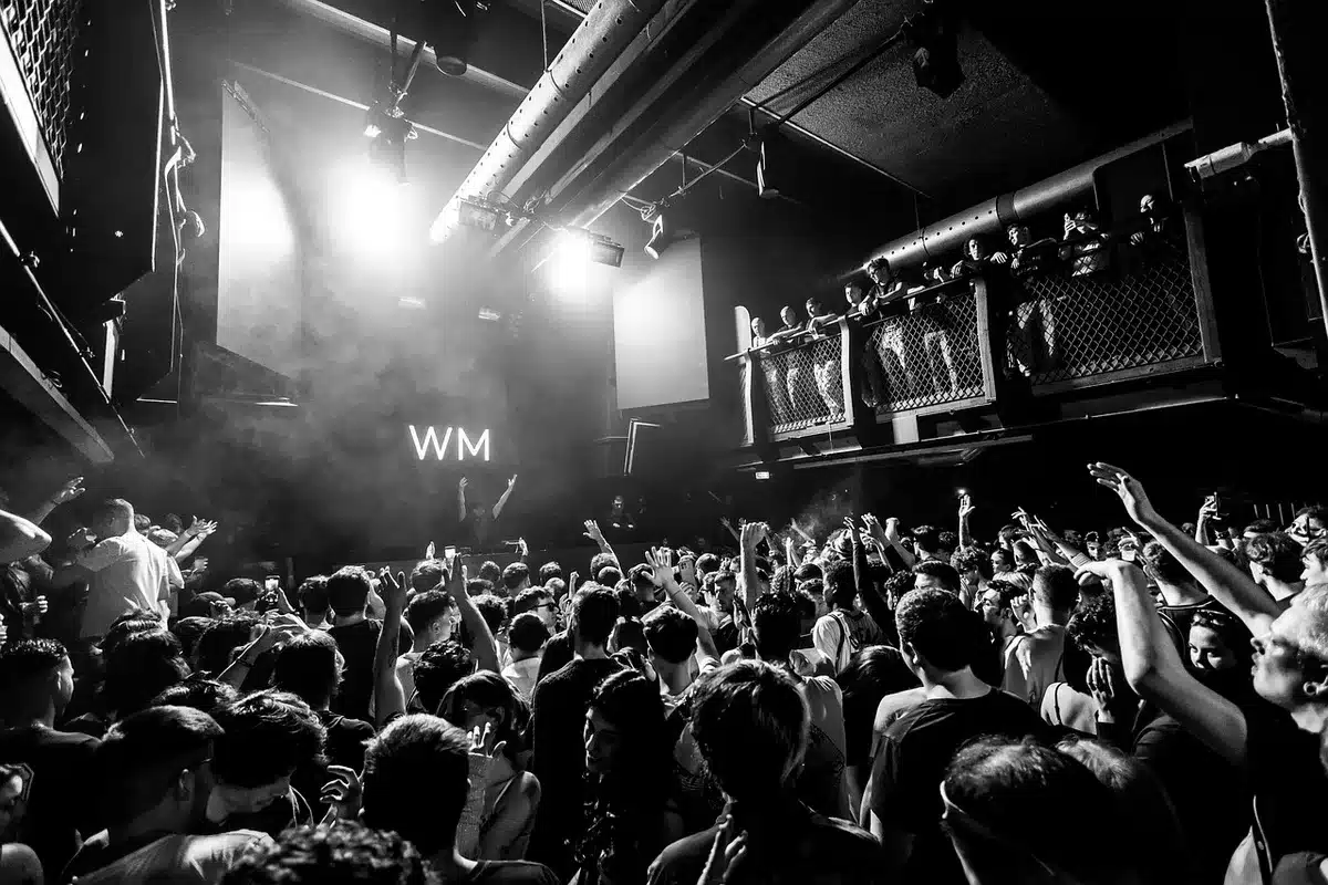 Crowd at a contemporary pop concert holding phones and streaming devices