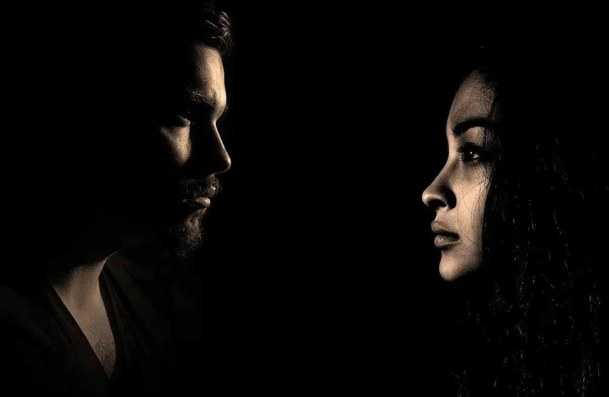 Two anonymous actors in contrasting lighting to suggest generational chemistry