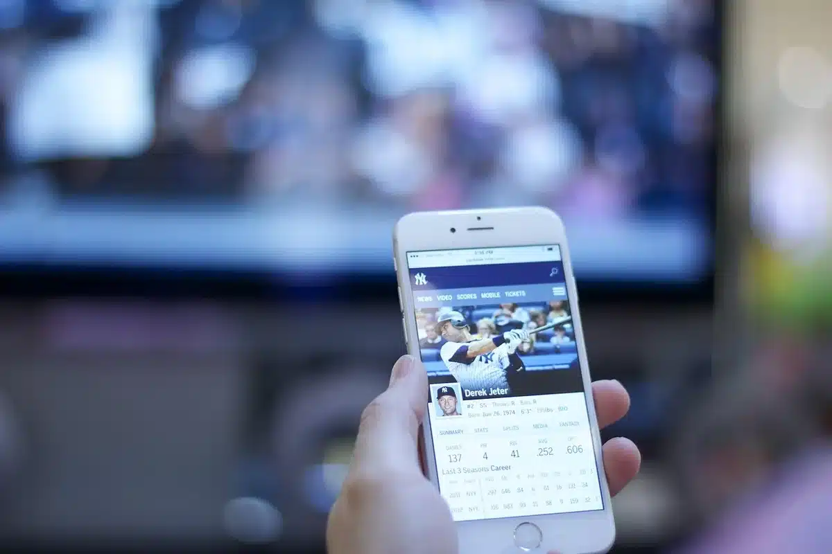 Unbranded TV remote beside a screen listing streaming apps and channel tiles