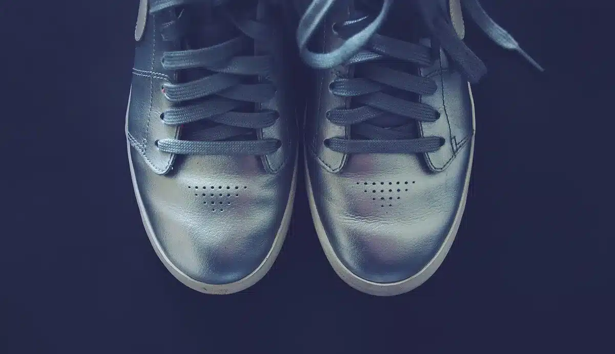 Close-up of two laces layered on a sneaker showing different textures