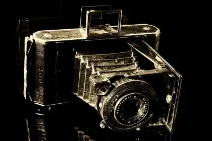 Silhouette of a film set with clapboard and camera rig, anonymous crew in studio