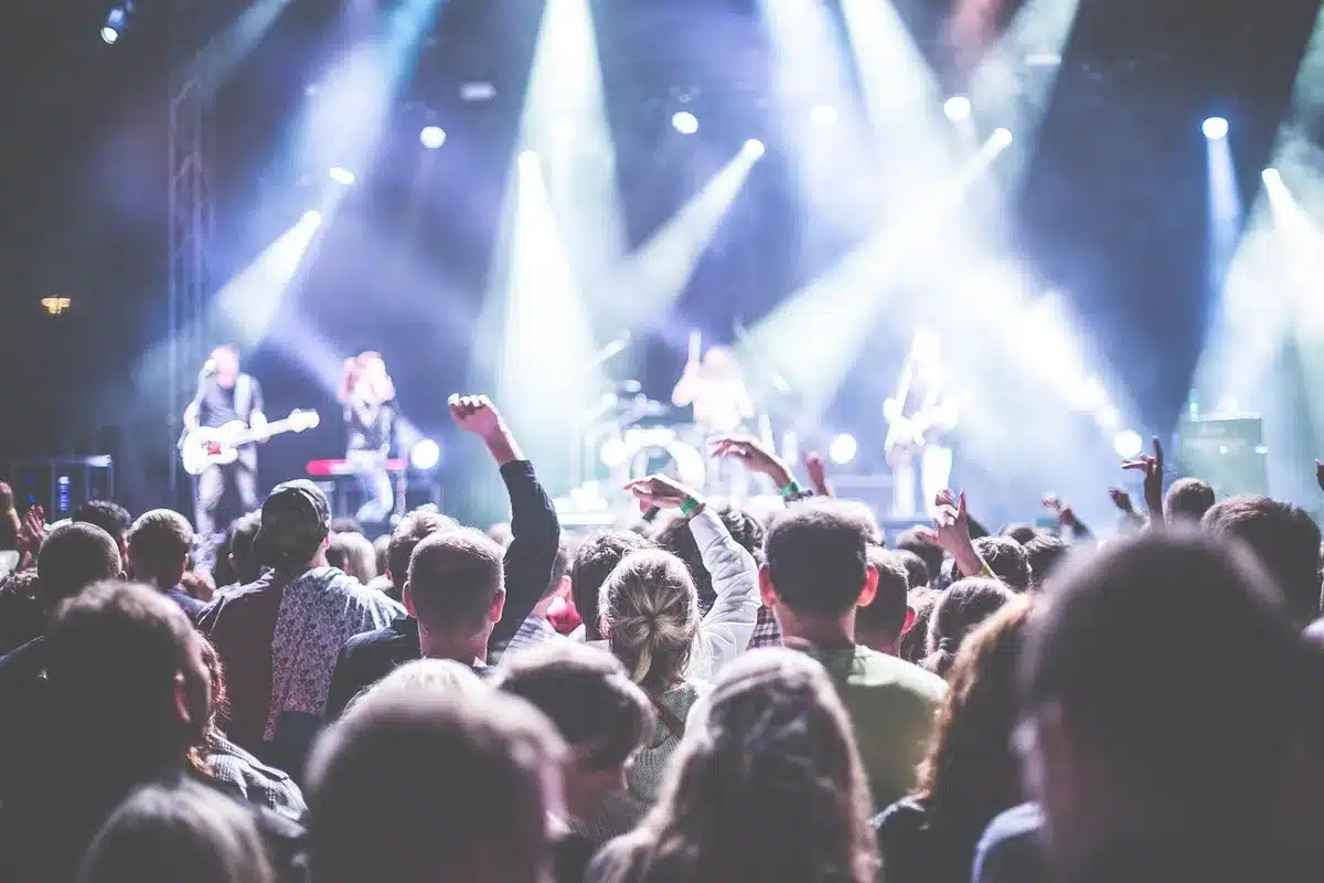 Audience watching a band in focused, cinematic lighting