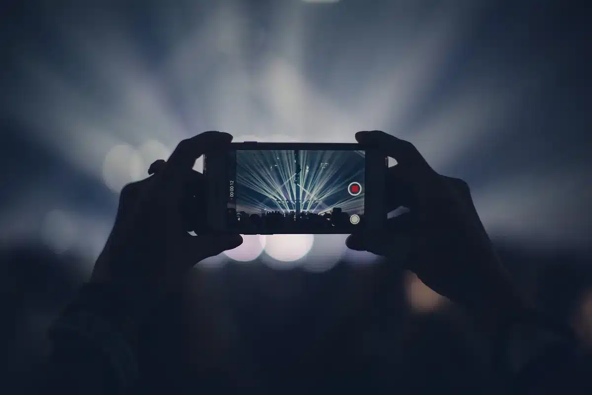 Streaming app graph overlayed with concert crowd