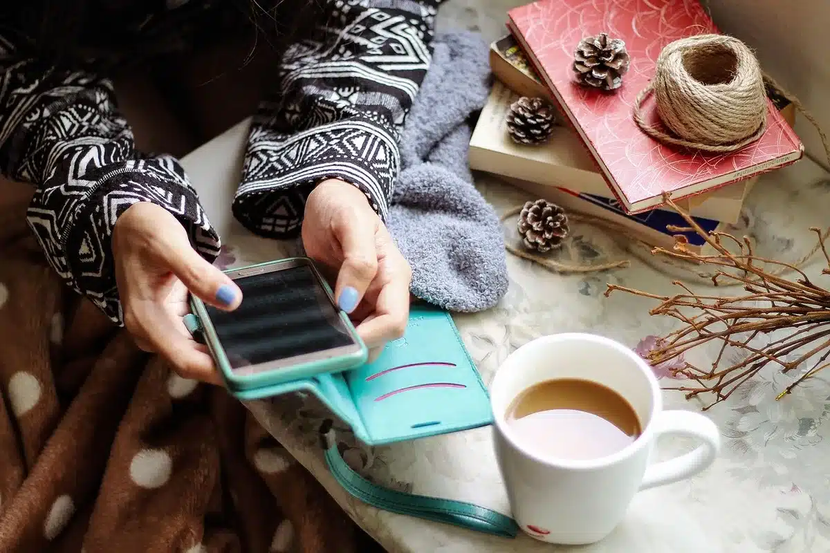 Hands holding a smartphone showing a short video clip of a couple scene
