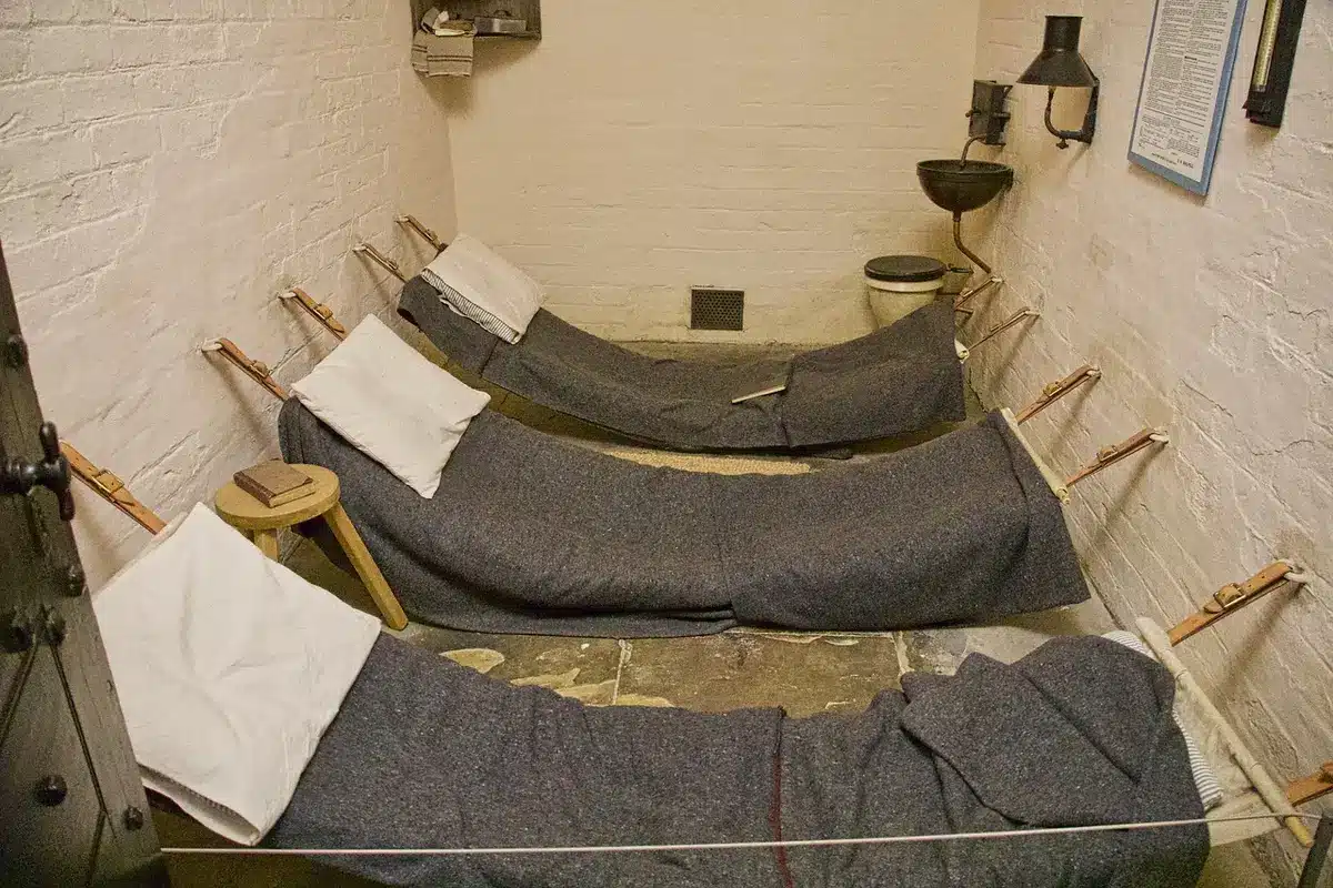 Prison communal area with nondescript bunk and a closed locker