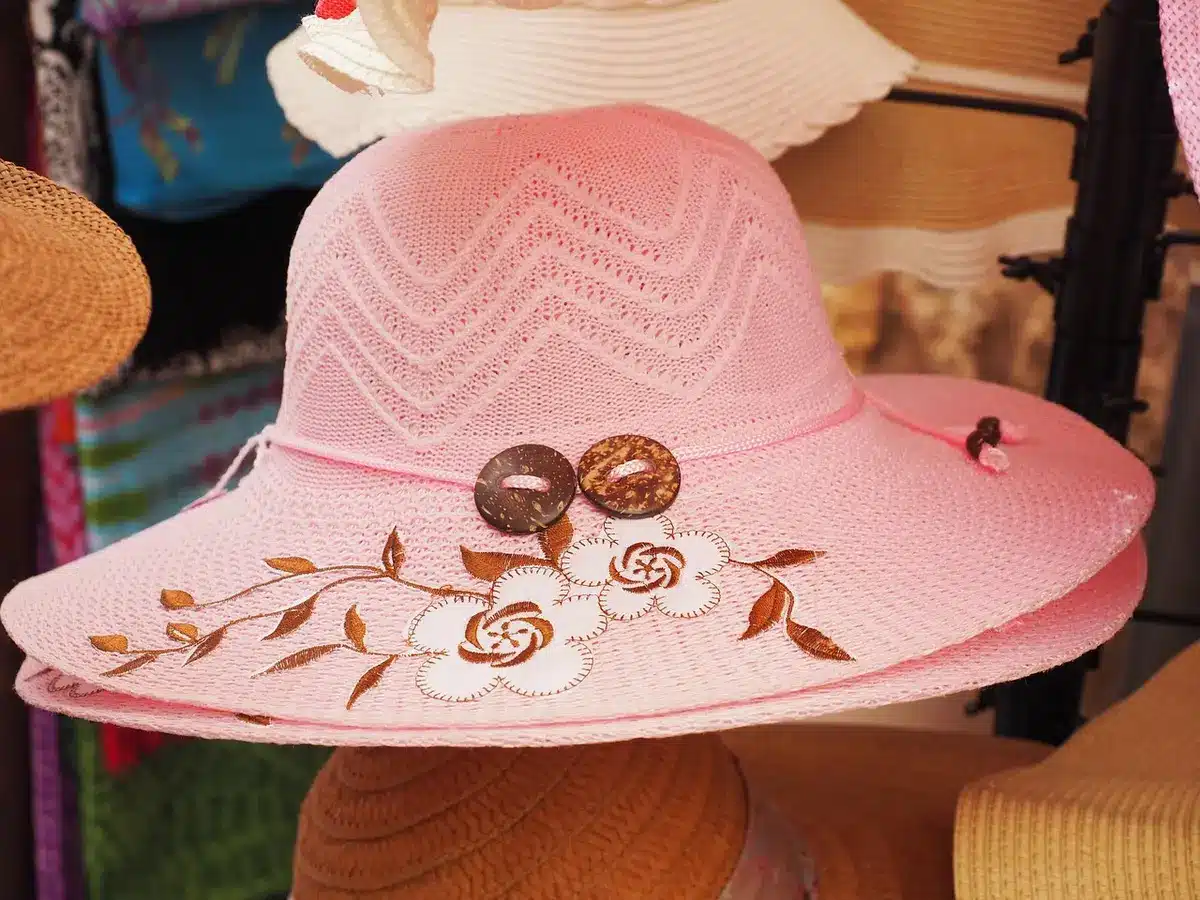 Wide-brim hat and sequin dress displayed together in a shop