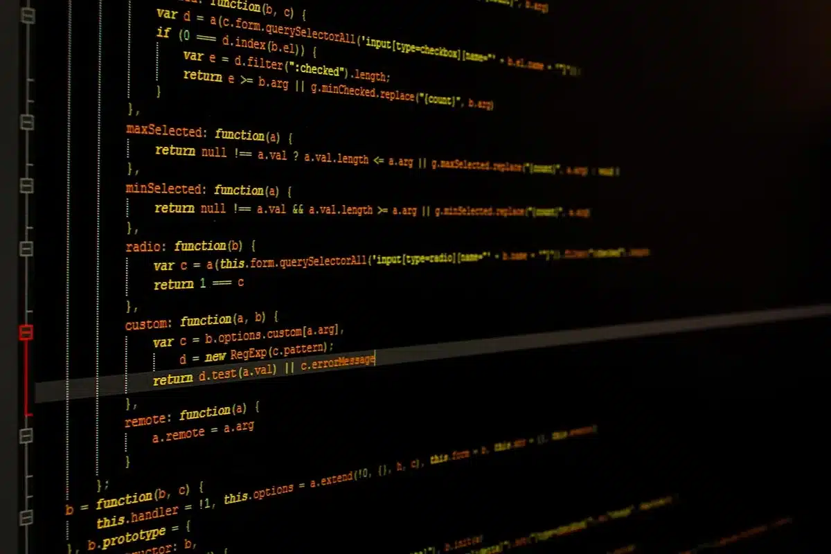 Developers reviewing code on laptops in a newsroom setting