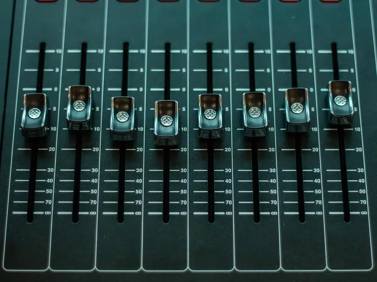 Empty recording studio mixing console and headphones on a desk