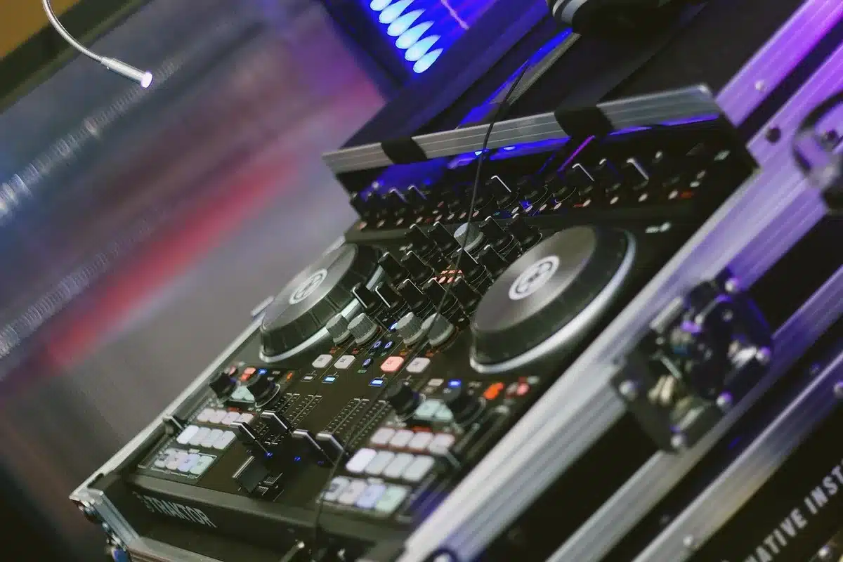Anonymous DJ at a radio mixing console wearing headphones in a studio