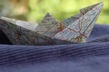 Rental car dashboard with map and binoculars pointing toward a coastal highway
