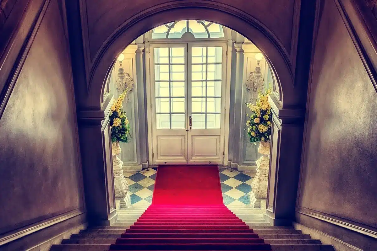 Guests arriving on a museum red carpet at night