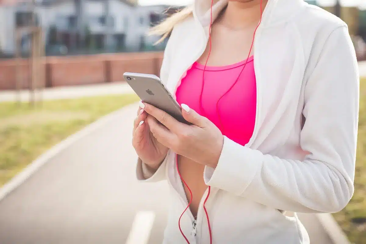 Person watching an interview on a smartphone with headphones